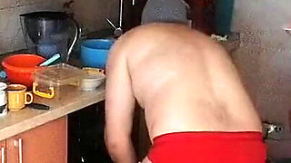 Couple Having Fun in the Kitchen. Sexy Wife Doing Chores in the House Naked