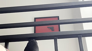 Caged Slave Girl in Knee High Socks Rubs Feet Against Bars