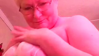 Dirty granny granny plays with her huge boobs and shows her bunny tail for you