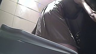 Brunette amateur white woman pisses in the toilet on hidden cam