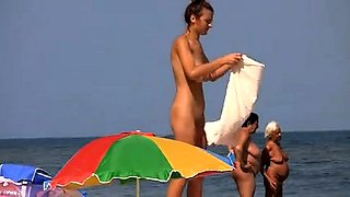 Beach voyeur spies on a busty brunette with a fabulous ass