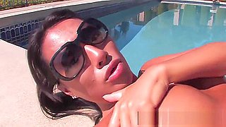 Asa Akira lays out by her pool and gets oiled up