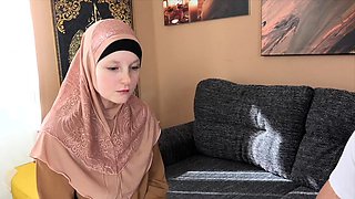 A woman in a hijab has to pay for a mistake