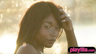 Petite Ebony mature strips naked in a pool