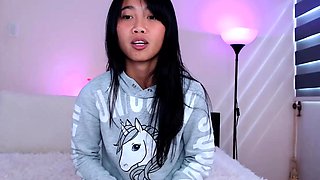 Asian teen plays with toys on webcam