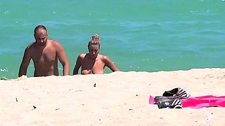 Hot nudist chick secretly filmed on the beach by a voyeur