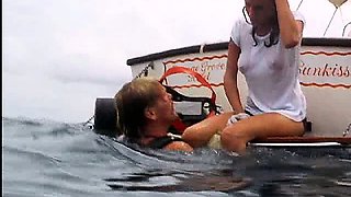 Jacqueline Bisset scuba diving in a white t-shirt that