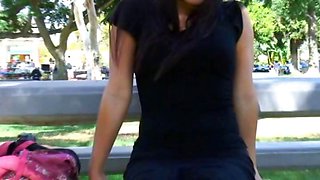 Sexy Asian is outside on a park bench showing off her