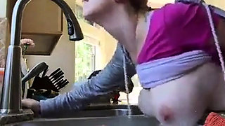 Bent over the kitchen sink
