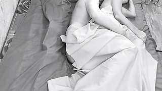 Couple caught on camera having sex in bed .
