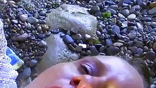 The MILF is a slut with huge breasts and a shaved vagina enjoying a cock inside her pussy on the beach