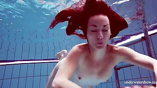 Skinny girl out in the pool cosplaying nirvana album cover underwater