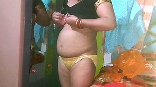 Indian housewife is wearing a yellow saree.