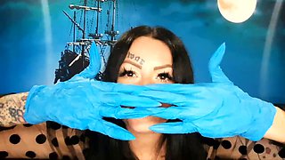Dominatrix Nika with a glove fetish puts on medical gloves and destroys them with her long tools