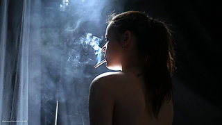 Topless Brunette Smoking in Dramatic Smoke