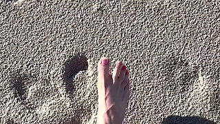 Comparing Size 16 Feet to Sand Prints at the Beach