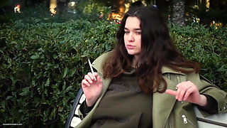 Young Brunette Is Taking an Unhurried Stroll with Allwhite 120mm Cigarette
