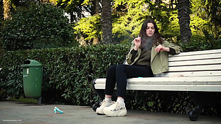 Young Brunette Is Taking an Unhurried Stroll with Allwhite 120mm Cigarette