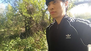 Freeballing public twink walks outdoors commando no underwear beneath black Adidas tracksuit Campus sneakers while out cruising